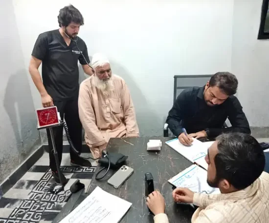 Dr Gulfam Checking Patient on free camp at Hashmi Hospital